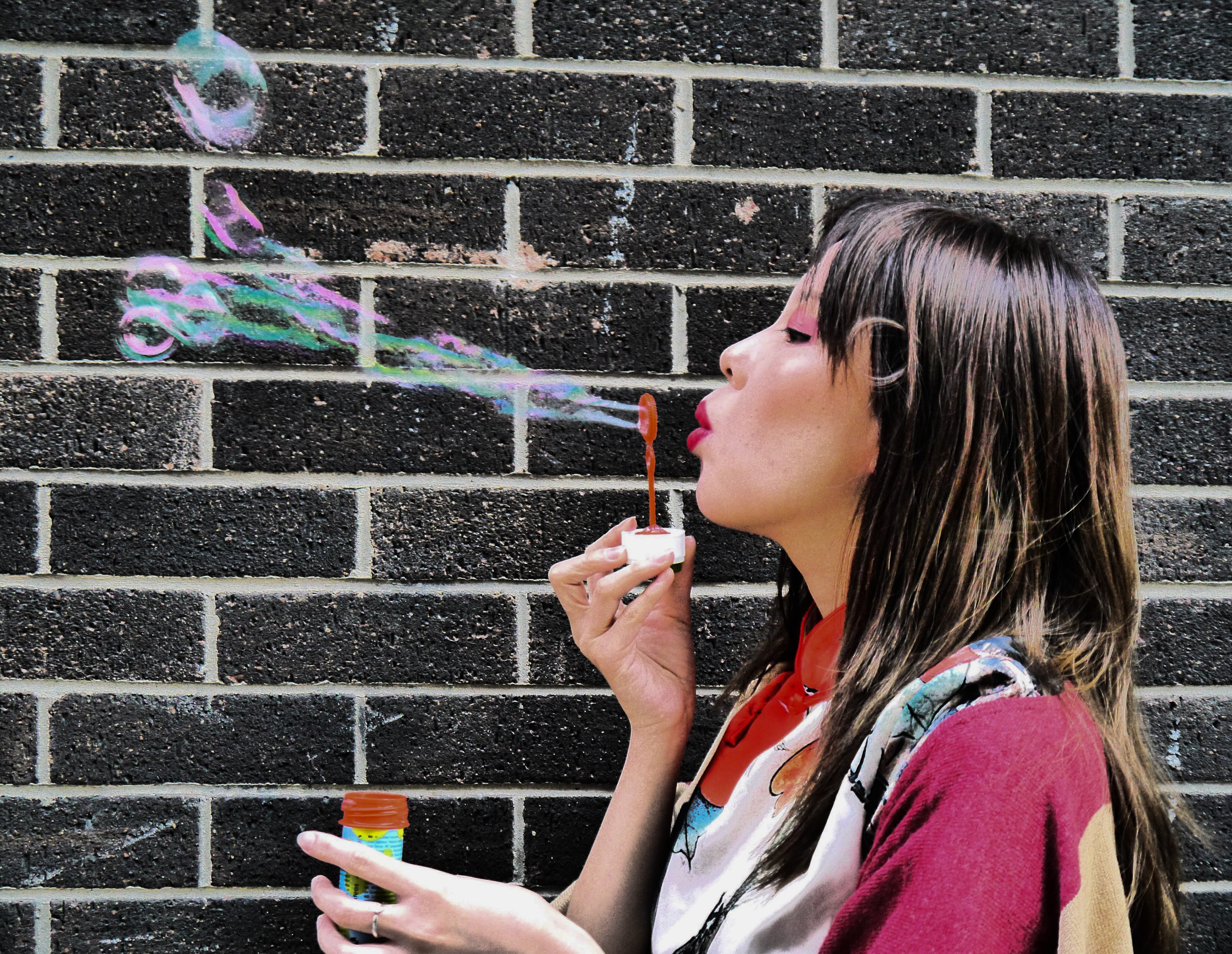 Photograph of woman blowing bubbles as an example of good Photographic exposure